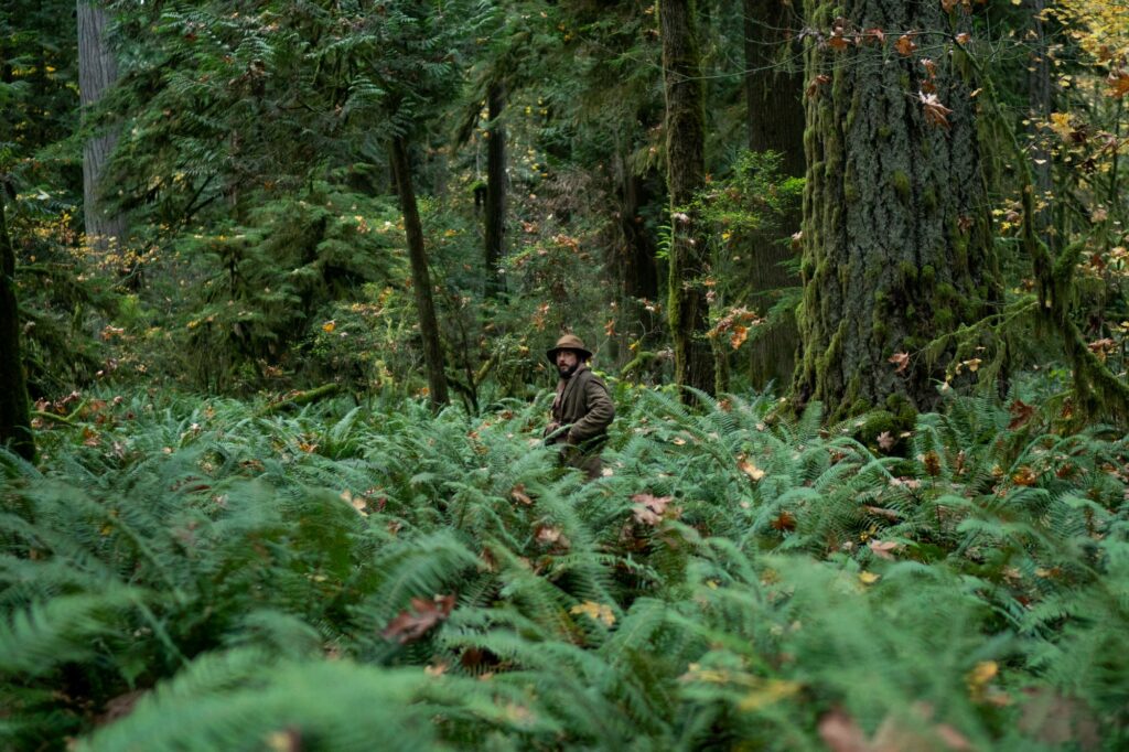 John Magaro in the woods as Cookie in First Cow