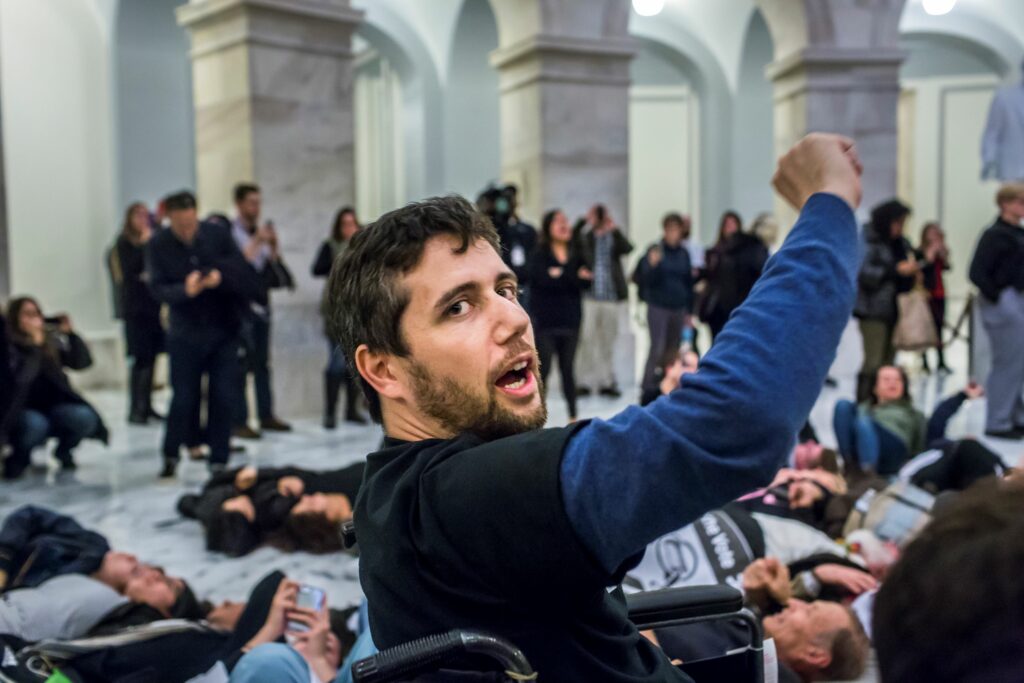 Not Going Quietly documentary by Nicholas Bruckman sees Ady Barkan raising his fist in Capitol Hill