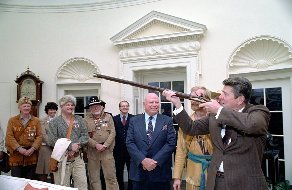 12/7/1981 President Reagan being presented a handmade classic flintlock muzzle loading rifle in the Oval Office by Harlon Carter in documentary The Price of Freedom by Judd Ehrlich