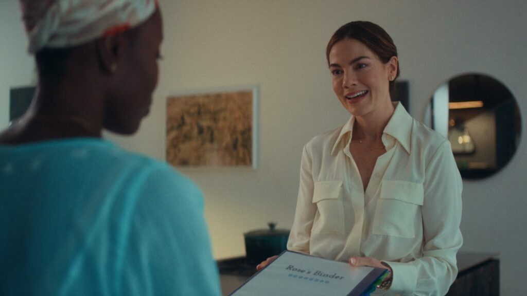 Aisha (Anna Diop) is handed a binder by Amy (Michelle Monaghan) in Nanny